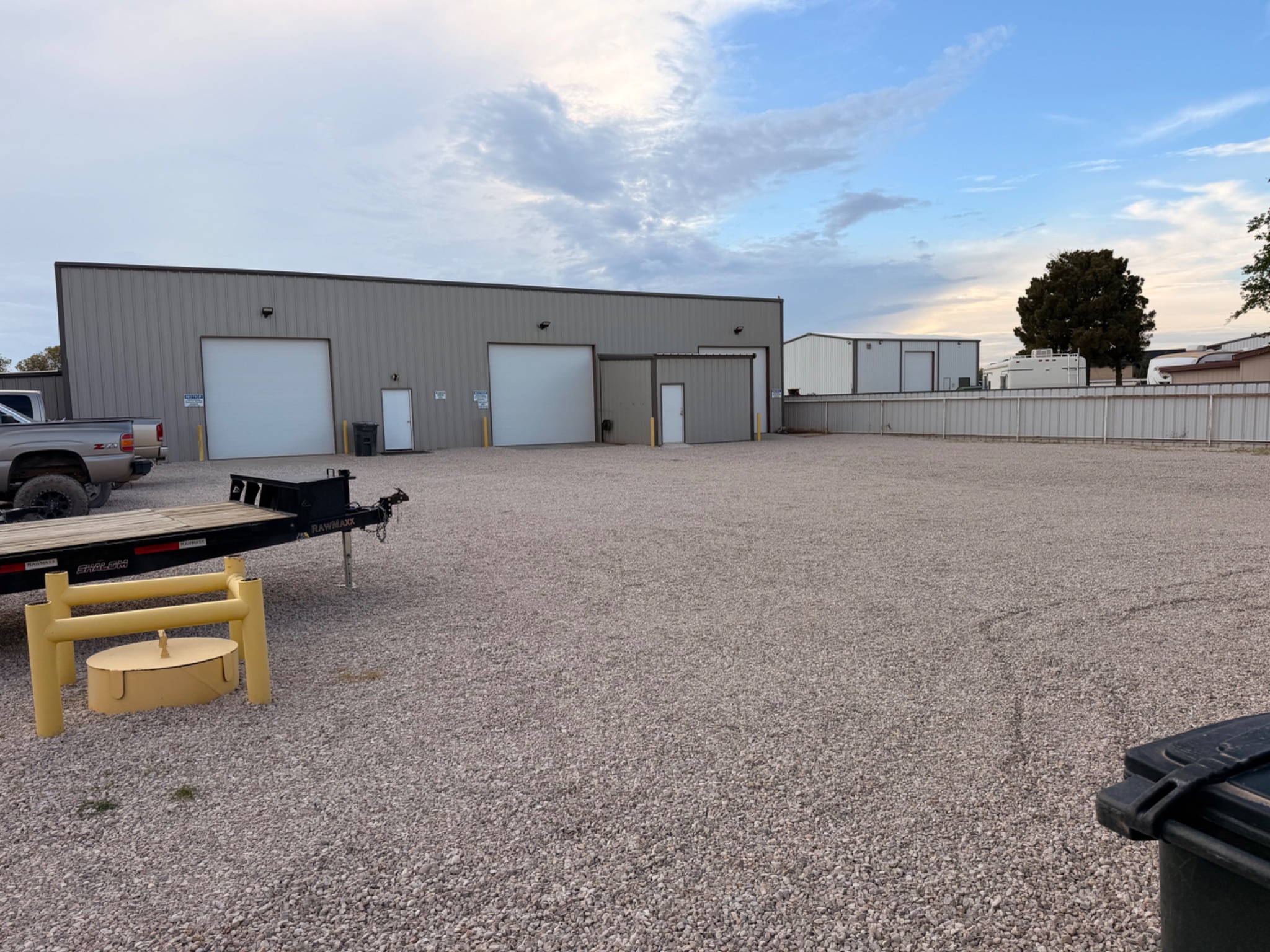 Commercial shop with overhead doors and gravel yard at 4013 Rio Arriba Road